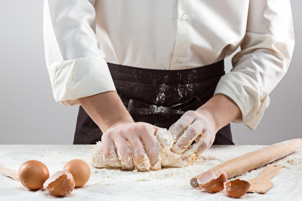 Hands kneading a dough